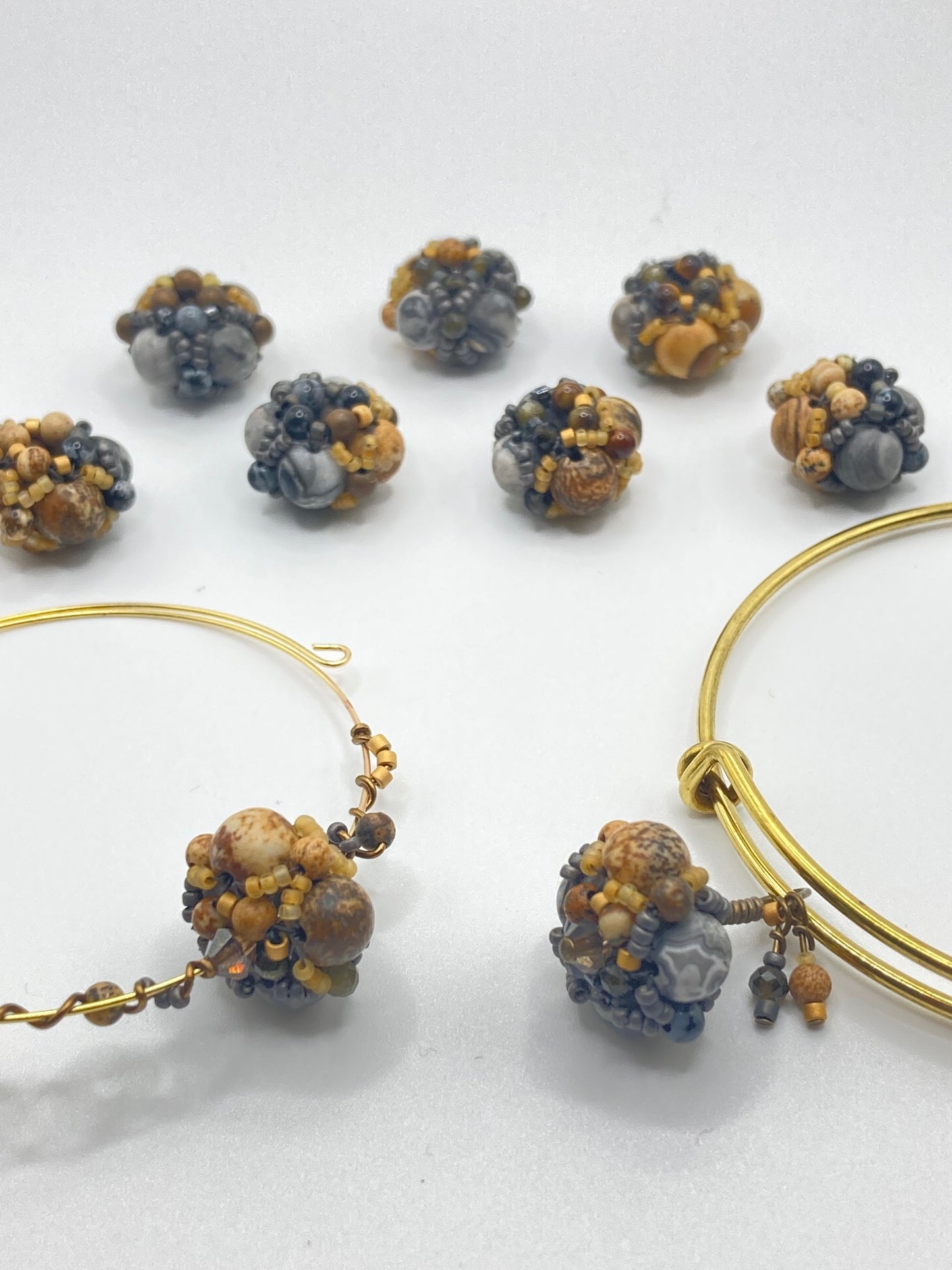 Inspired by the glacial potholes of Shelburne Falls, MA. Beautifully hand sewn beaded bracelet made with gray jasper, pyrite, hematite, picture jasper, golden obsidian and tiger's eye semi-precious stones. Perfect gift for those who are nature-inspired.