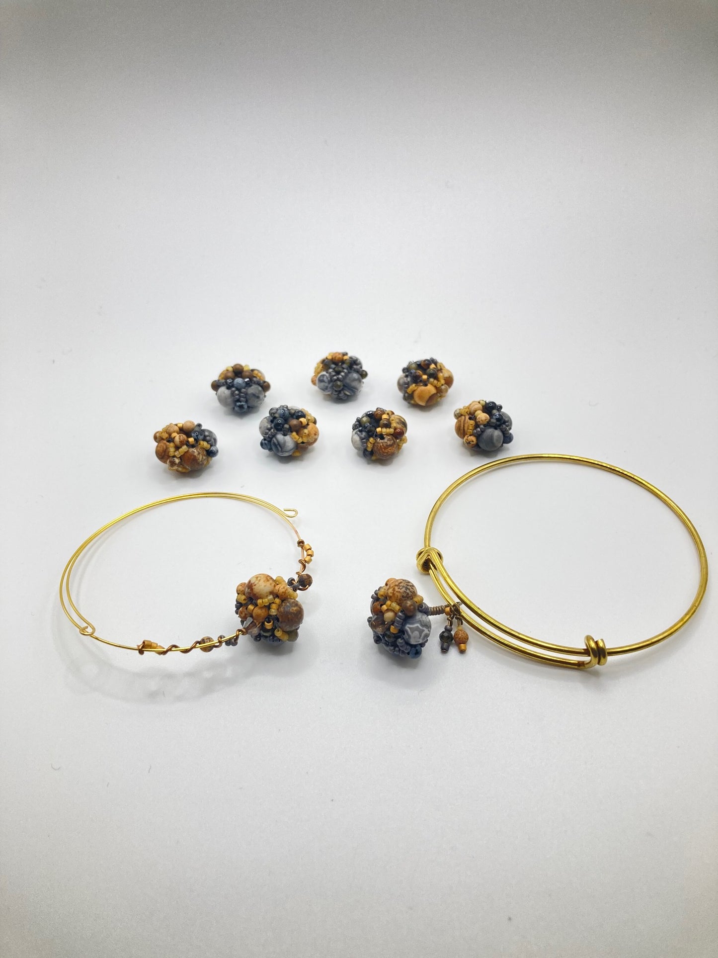 Inspired by the glacial potholes of Shelburne Falls, MA. Beautifully hand sewn beaded bracelet made with gray jasper, pyrite, hematite, picture jasper, golden obsidian and tiger's eye semi-precious stones. Perfect gift for those who are nature-inspired.